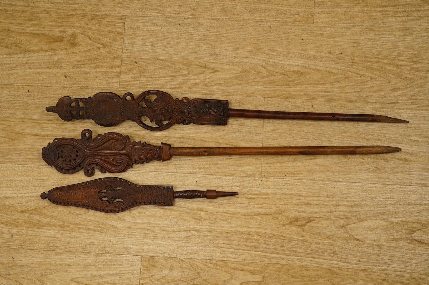 Three 19th century Russian or Eastern European treen distaffs, longest 77cm. Condition - fair to good, one with missing bottom section